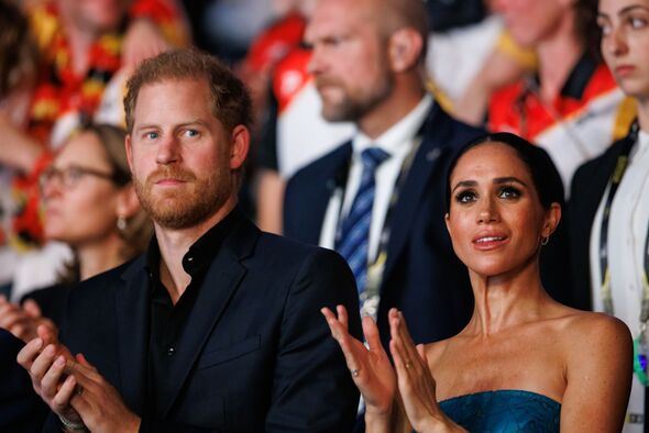 Prince Harry and Meghan Markle applaud