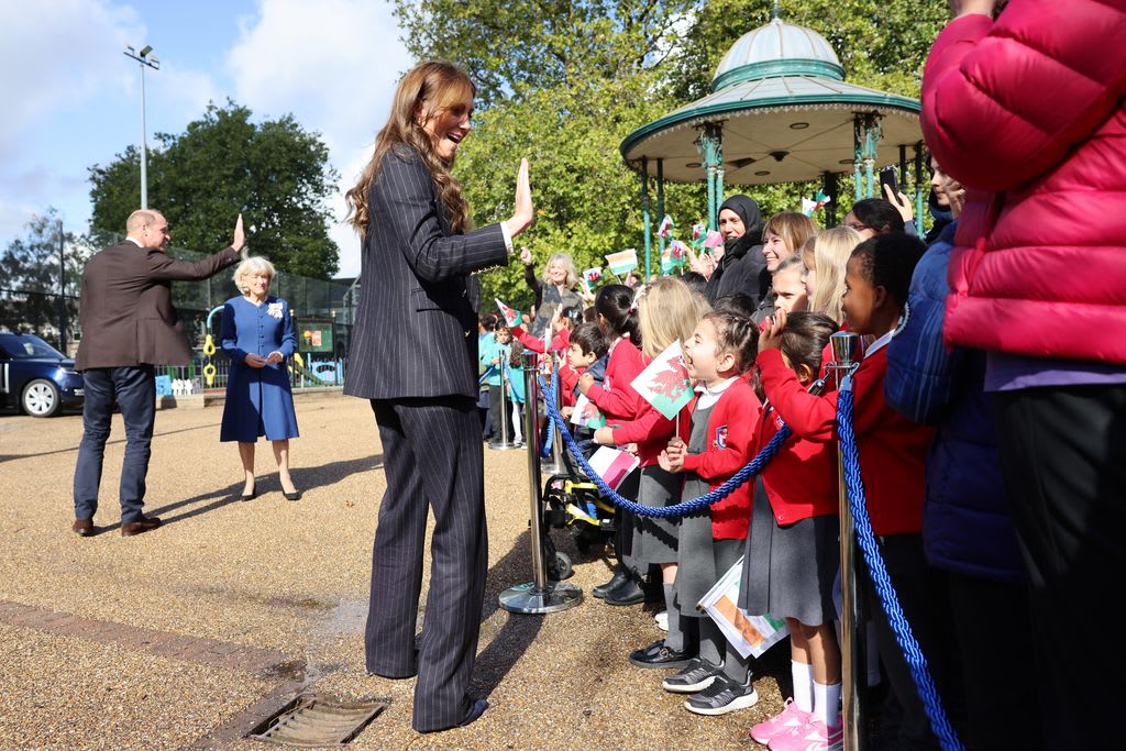 William and Kate wave to school children as they depart from the Grange Pavilion