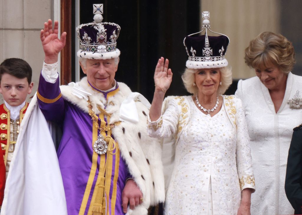 King Charles and Queen Camilla waving at their coronation