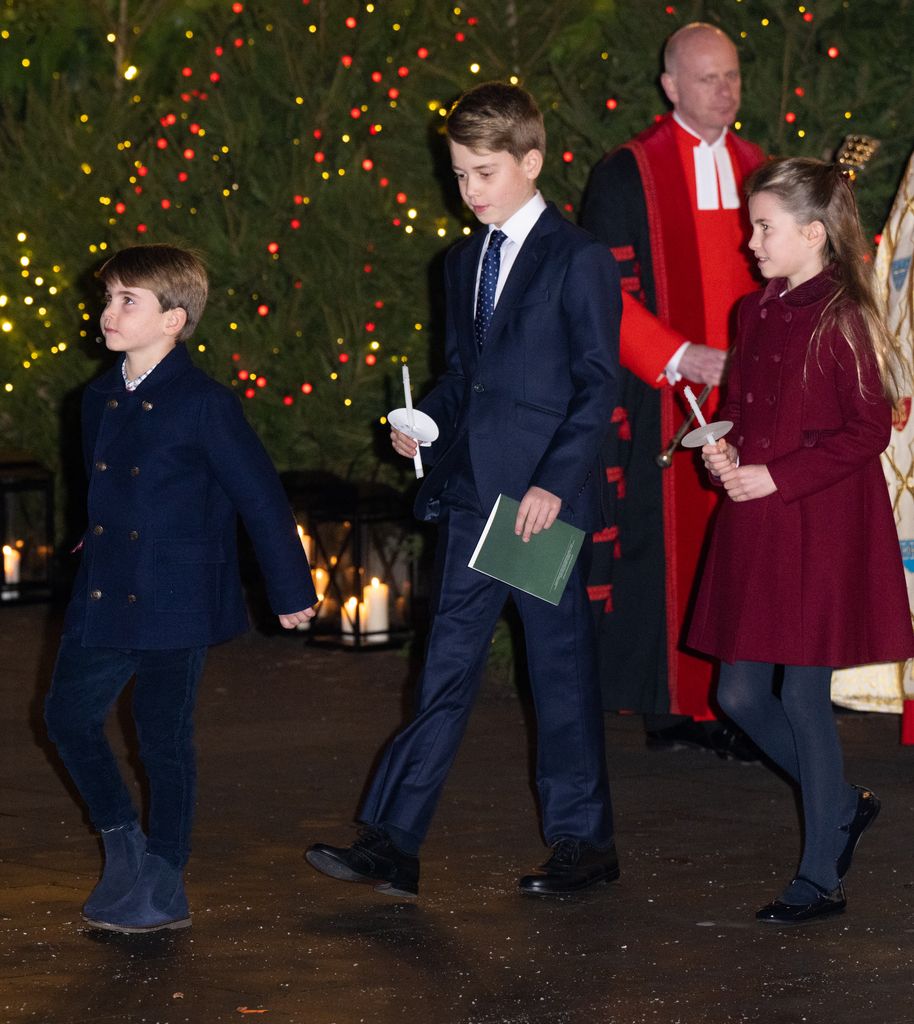 George, Charlotte and Louis holding candles at carol service