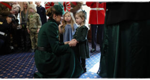 Princess Kate interacting with a young girl during the Irish Guards St Patrick's Day celebration