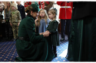 Princess Kate interacting with a young girl during the Irish Guards St Patrick's Day celebration