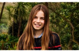 Princess Charlotte smiling in a candid photo showing her longest hair yet for her 11th birthday